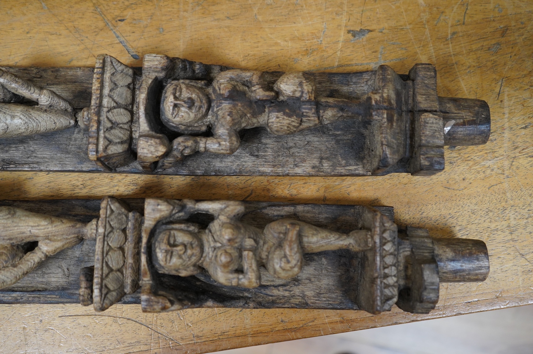 A pair of 19th century Indian carved wood figural pilasters - 74cm long